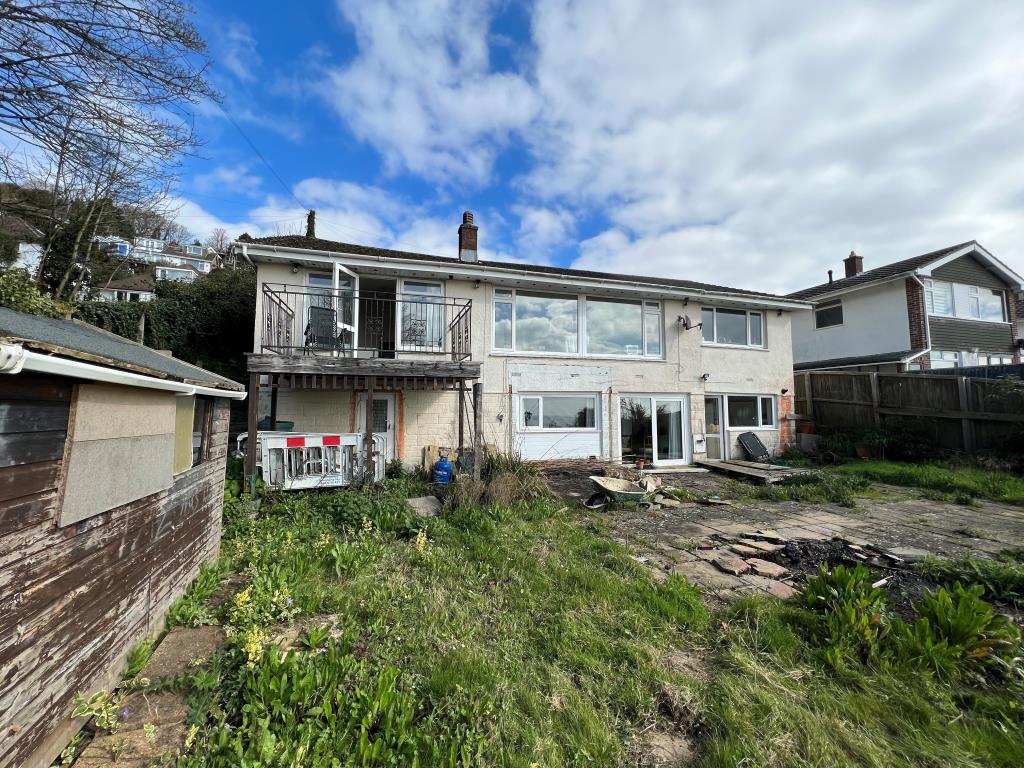 Lot: 99 - HOUSE WITH SEA VIEWS WITH CONSENT FOR DEMOLITION AND CONSTRUCTION OF SIX TWO-BEDROOM APARTMENTS - Rear photo of bungalow with sea views in Ventnor Isle of Wight